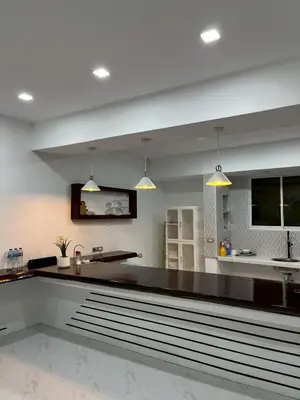 a kitchen with a black counter and a sink at Nur Nur Residence and villa in Surin Beach