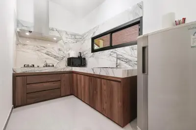 a kitchen with marble counter tops and a sink at Palm Village in Rawai Beach