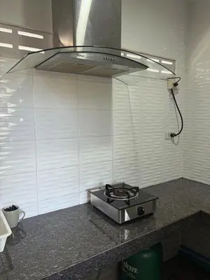 a stove top on a counter in a kitchen at Cozy 1-Bedroom apartment in Surin Beach