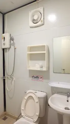 a bathroom with a toilet and a sink at Wings Alley Phuket in Phuket