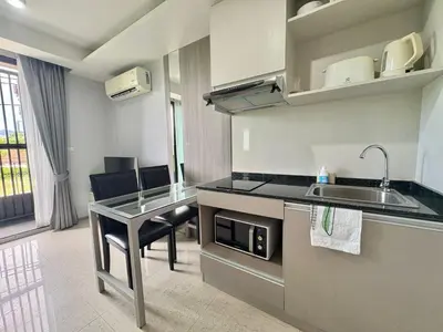 a kitchen with a sink and a table with chairs at 1 Bedroom l 6th Avenue l Surin beach in Surin Beach