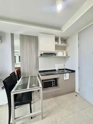 a kitchen with a glass table and black chairs at 1 Bedroom l 6th Avenue l Surin beach in Surin Beach