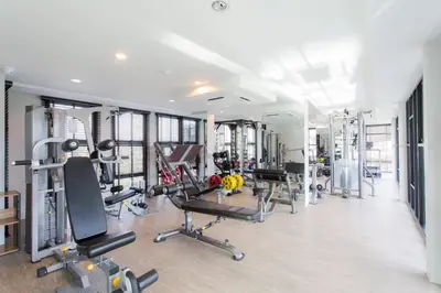 a gym with several treadmills and machines at 1 Bedroom l 6th Avenue l Surin beach in Surin Beach
