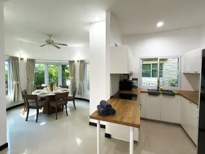 a kitchen and dining room with a table and chairs at Nai Harn Family Pool Villa 3 BDR by Mill in Ban Saiyuan (1)