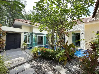 a house with a garden and a swimming pool at Nai Harn Family Pool Villa 4 bdr in Ban Saiyuan (1)