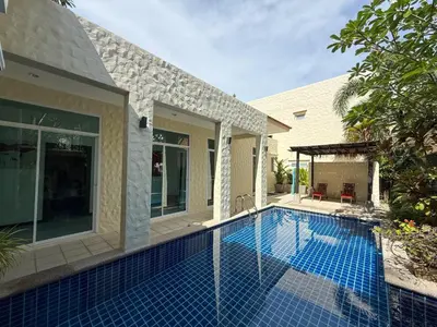 a swimming pool in front of a house at Nai Harn Family Pool Villa 4 bdr in Ban Saiyuan (1)