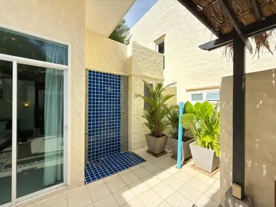 a patio with blue tile on the side of a house at Nai Harn Family Pool Villa 4 bdr in Ban Saiyuan (1)