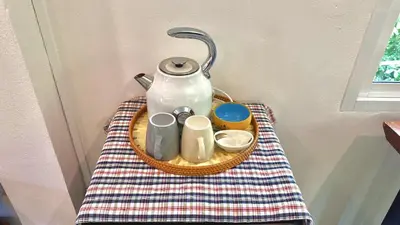 a tea pot sitting on a table with a towel at The Simple Place - King in Klong Muang Beach