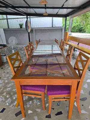 a wooden table with chairs and a glass top at The Simple Place - King in Klong Muang Beach