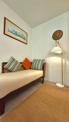 a living room with a couch and a lamp at The Simple Place - King in Klong Muang Beach