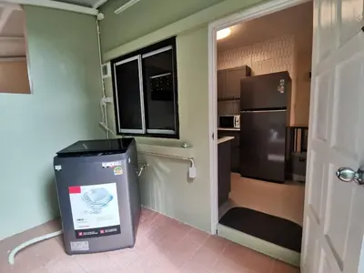 a kitchen with a trash can and a refrigerator at Kata Beach Townhouse 3 in Kata Beach
