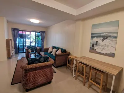 a living room with a couch and a table at Kata Beach Townhouse 3 in Kata Beach