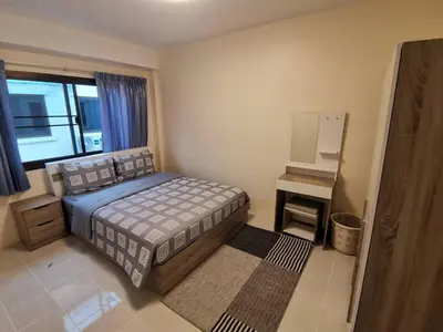 a bedroom with a bed and a television in it at Kata Beach Townhouse 3 in Kata Beach