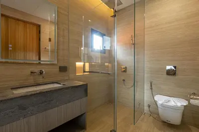 a bathroom with a shower with a toilet and a sink at Kiang Tawan Villa in Kamala Beach