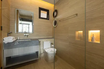 a bathroom with a toilet and a sink and a shower at Kiang Tawan Villa in Kamala Beach