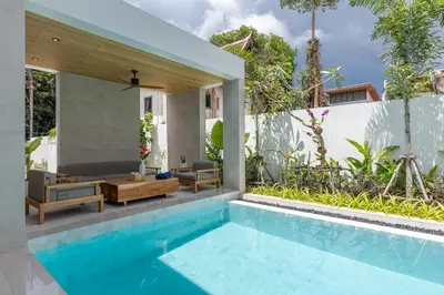 a pool in a villa with a house at Kiang Tawan Villa in Kamala Beach