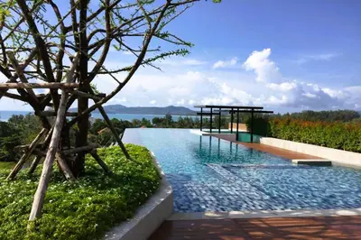 a swimming pool with a view of the water at AVN 1 BR Apt near beaches 15mn walk in Surin Beach