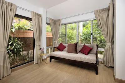 a living room with a couch and large windows at Villa Hillside 2-story-3BR-Private Pool near Big Buddha in Ban Klang