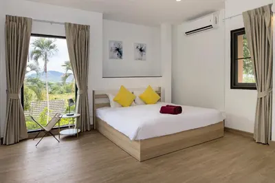 a bedroom with a bed and a large window at Villa Hillside 2-story-3BR-Private Pool near Big Buddha in Ban Klang