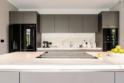 a kitchen with a white counter top with a bowl of fruit at Grand View Lagoon - private paradise in Phuket in Ban Thalat Choeng Thale