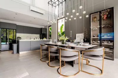a dining room with a table and some chairs at Grand View Lagoon - private paradise in Phuket in Ban Thalat Choeng Thale