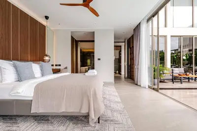 a bedroom with a large bed and a balcony at Grand View Lagoon - private paradise in Phuket in Ban Thalat Choeng Thale