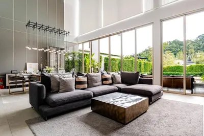 a living room with a couch and a coffee table at Grand View Lagoon - private paradise in Phuket in Ban Thalat Choeng Thale
