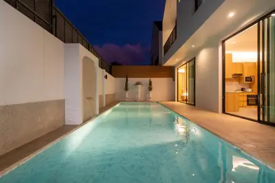 a swimming pool in the middle of a house at Wanila Villa Bangtao Beach Brand New Luxury Modern Pool Villa Laguna Phuket in Thalang