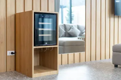 a television in a wooden stand in a living room at Wanila Villa Bangtao Beach Brand New Luxury Modern Pool Villa Laguna Phuket in Thalang