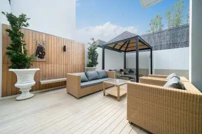 a patio with a couch and a gazebo at Wanila Villa Bangtao Beach Brand New Luxury Modern Pool Villa Laguna Phuket in Thalang