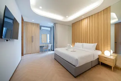 a bedroom with a bed and a television in it at Wanila Villa Bangtao Beach Brand New Luxury Modern Pool Villa Laguna Phuket in Thalang