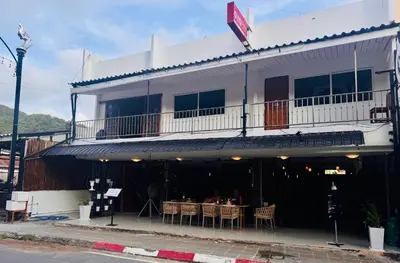 a white building with a table in front of it at SET INN Restaurant & Bar in Kata Beach