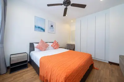 a bedroom with a bed and a ceiling fan at Happy 3 bedroom Townhouse Laguna Park in Laguna Phuket