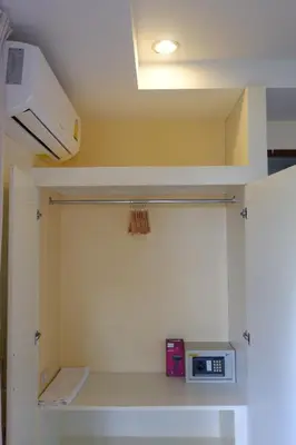 a room with a microwave sitting on a shelf at The Cozy House in Karon Beach