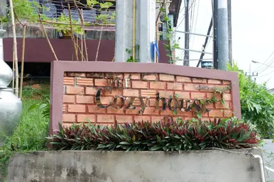 a brick wall with the word love written on it at The Cozy House in Karon Beach