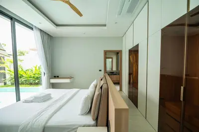 a bedroom with a bed and a large window at Mouana Residence Song Khun Chalong 4-bedroom Pool Villa 893 in Chalong