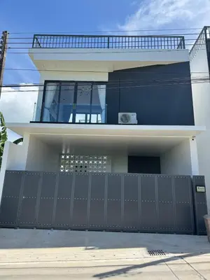 a house with a black fence in front of it at Brand new Luxury Pool Villa Seaview Rooftop in Ban Saiyuan (1)