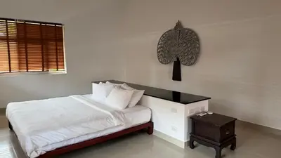 a white bedroom with a bed and a table at The Majestic Estate - 6 Bedroom Private Villa in Ban Bang La