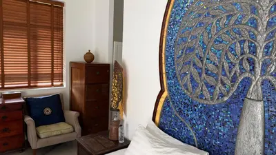 a bedroom with a bed with a large painting on the wall at The Majestic Estate - 6 Bedroom Private Villa in Ban Bang La