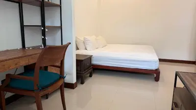 a bedroom with a bed and a desk and a chair at The Majestic Estate - 6 Bedroom Private Villa in Ban Bang La