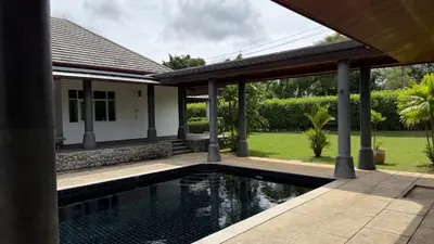 a swimming pool in front of a house at The Majestic Estate - 6 Bedroom Private Villa in Ban Bang La