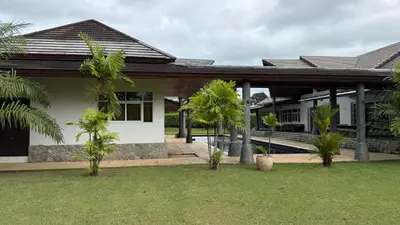 a house with palm trees in the yard at The Majestic Estate - 6 Bedroom Private Villa in Ban Bang La