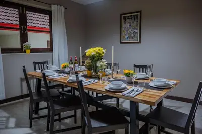a wooden table with chairs and a dining room at Ton Sai Villa - 7 bedroom pool villa - Paklok in Ban Chin Tham Mai