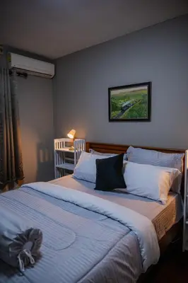 a bedroom with a large bed and a table at Ton Sai Villa - 7 bedroom pool villa - Paklok in Ban Chin Tham Mai