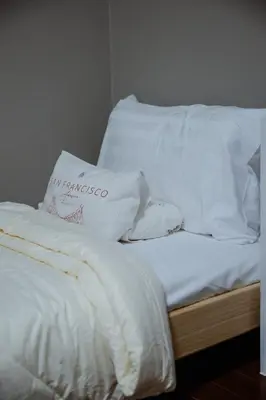 a bed with white sheets and pillows on it at Ton Sai Villa - 7 bedroom pool villa - Paklok in Ban Chin Tham Mai