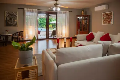 a living room with white couches and red pillows at Ton Sai Villa - 7 bedroom pool villa - Paklok in Ban Chin Tham Mai