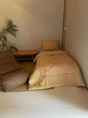 a bed sitting in a corner of a room at Pradu House Koh Yao Noi in Ko Yao Noi
