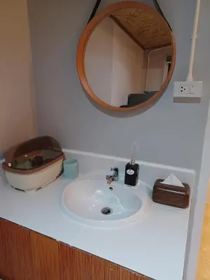 a bathroom sink with a mirror on a counter at Pradu House Koh Yao Noi in Ko Yao Noi