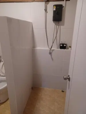 a bathroom with a shower stall with a toilet at Pradu House Koh Yao Noi in Ko Yao Noi