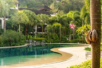 a swimming pool in front of a resort at Bangtao Beach Gardens - Pool & Garden View Apartment in Surin Beach